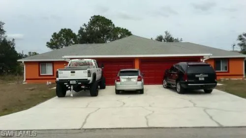 View of front facade featuring driveway and a garage