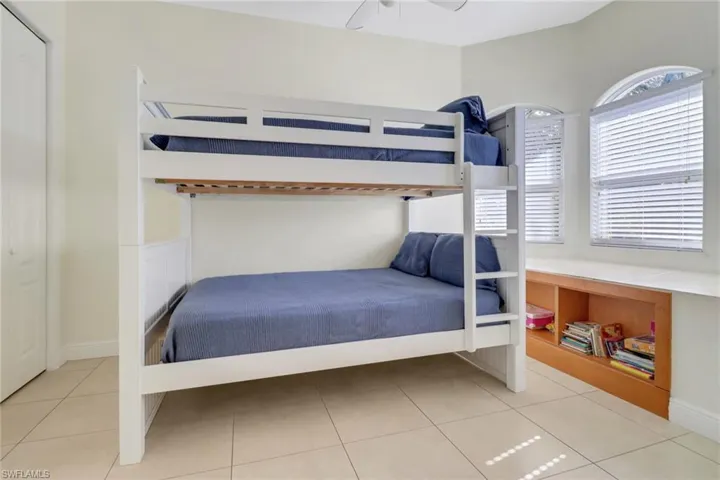Tiled bedroom with ceiling fan
