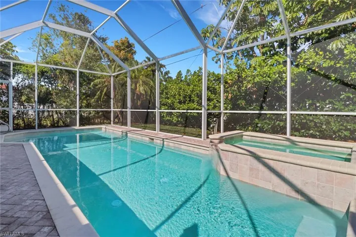 View of swimming pool with glass enclosure