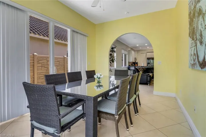 Tiled dining space featuring ceiling fan