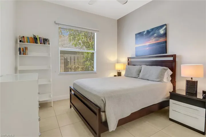 Bedroom with ceiling fan and light tile patterned flooring