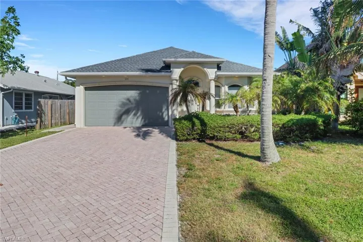 View of front of property with a garage and a front yard