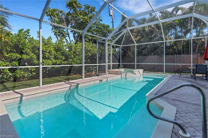 View of swimming pool with a lanai, an in ground hot tub, and a patio