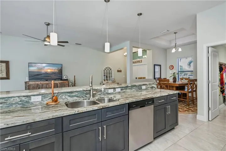 kitchen looking into dining area, great room, and front entry to home