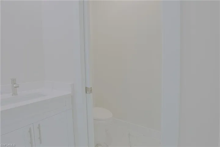 Bathroom with marble finish floors and vanity