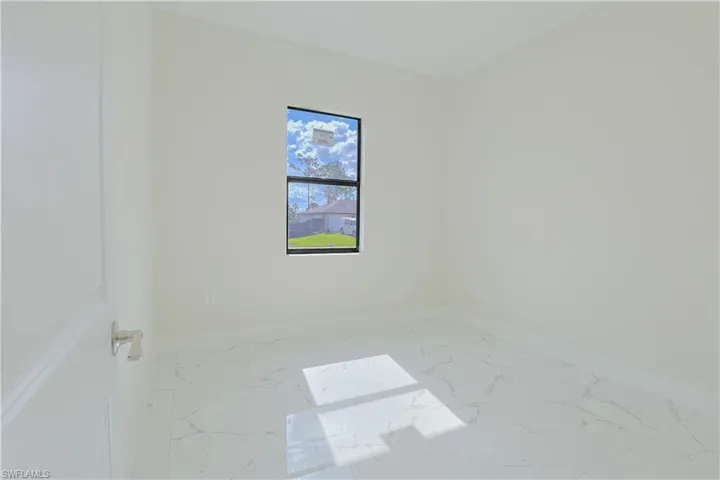 Empty room with marble finish floors and baseboards
