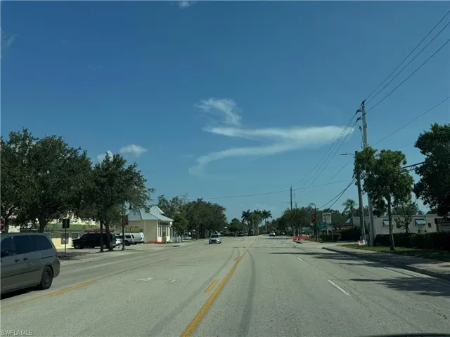 View of asphalt road with sidewalks and curbs