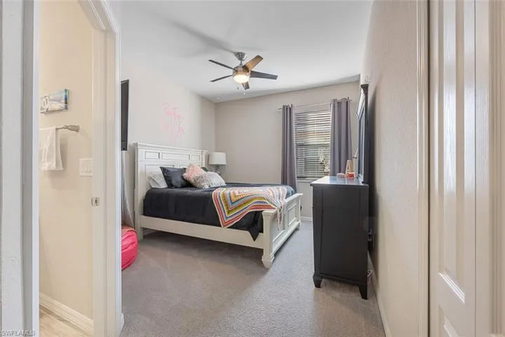 Carpeted bedroom with ceiling fan