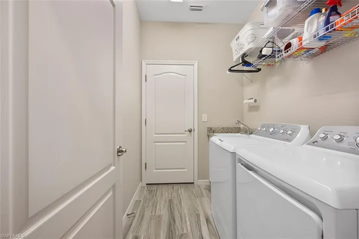 Washroom featuring sink and washing machine and dryer