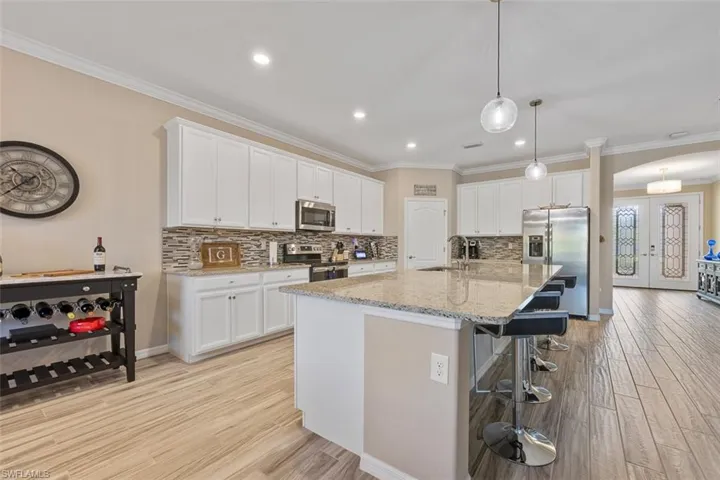Kitchen featuring french doors, stainless steel appliances, and white cabinets
