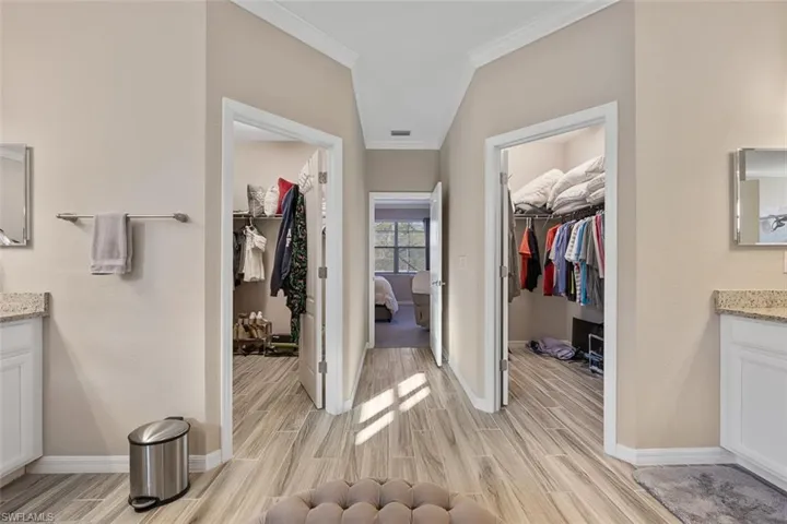 Bathroom with ornamental molding, hardwood / wood-style floors, and vanity