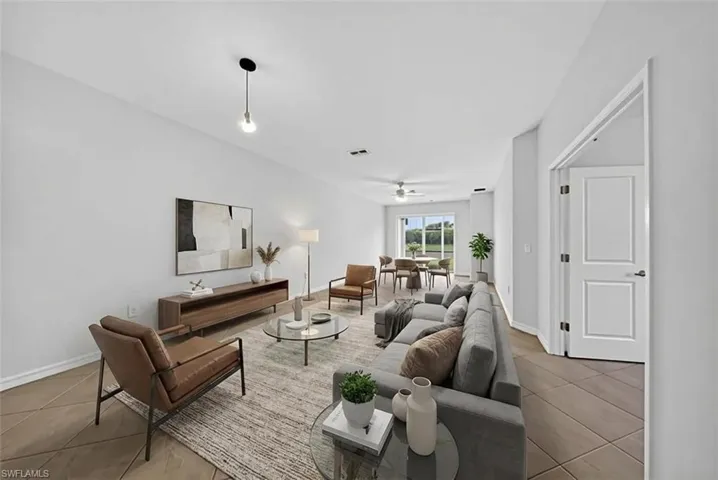 Living area featuring a ceiling fan and light tile patterned floors