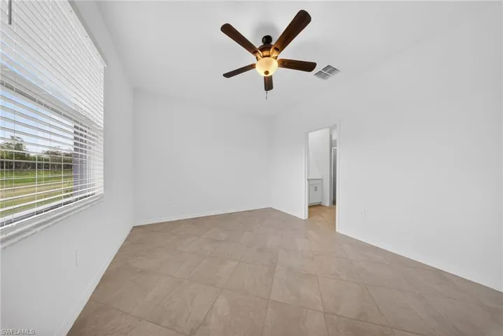 Spare room with a ceiling fan and baseboards