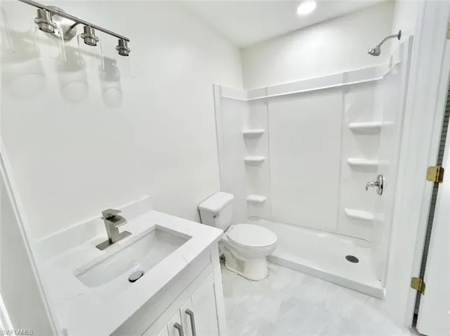 Bathroom with dual vanities, dual sinks, and shower.