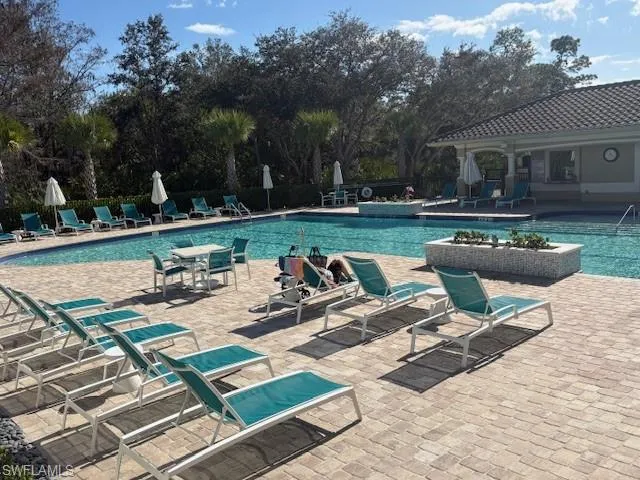 Community pool featuring a patio