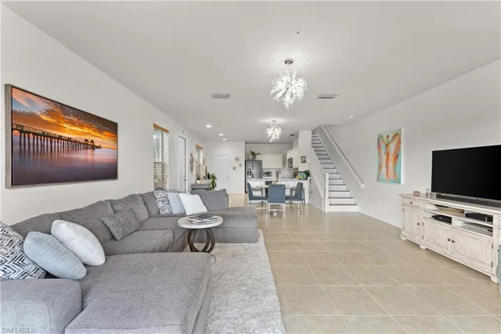 Tiled living room featuring an inviting chandelier
