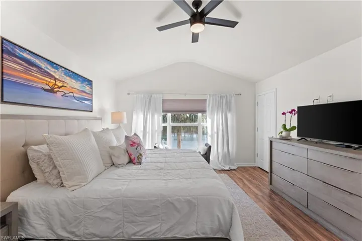 Bedroom featuring dark wood-type flooring, ceiling fan, and lofted ceiling