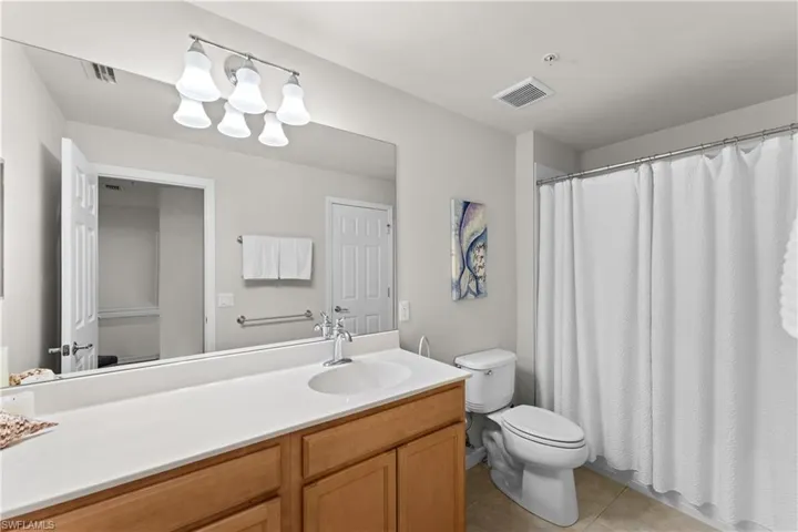 Bathroom with tile patterned flooring, vanity, and toilet