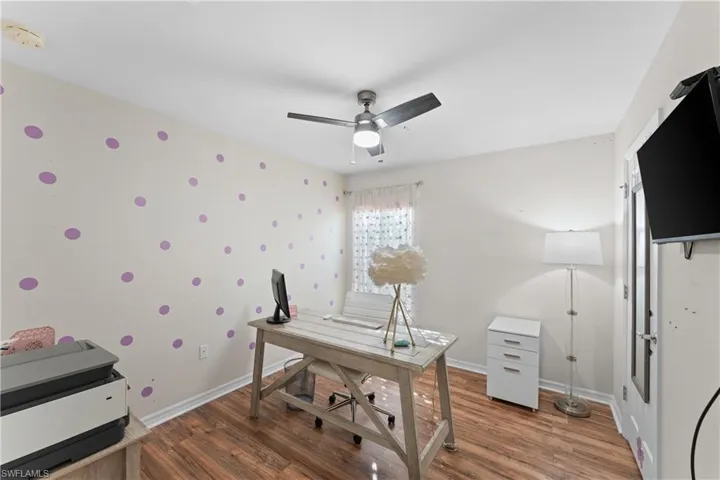 Office space with ceiling fan and dark hardwood / wood-style floors