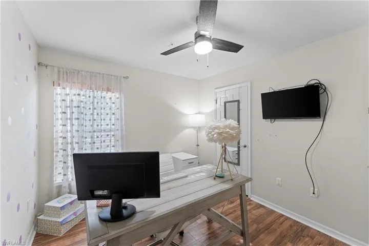 Office space featuring ceiling fan and wood-type flooring