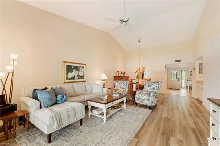 Vaulted ceilings, CoreTec luxury vinyl plank flooring, and a ceiling fan