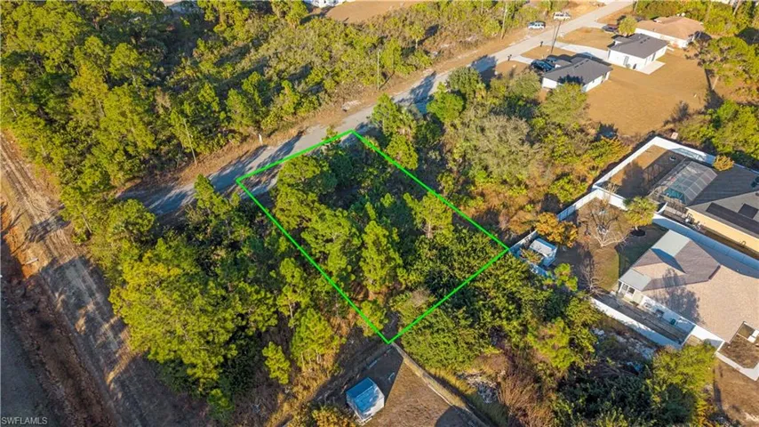 Aerial view of property and surrounding area featuring property boundaries highlighted