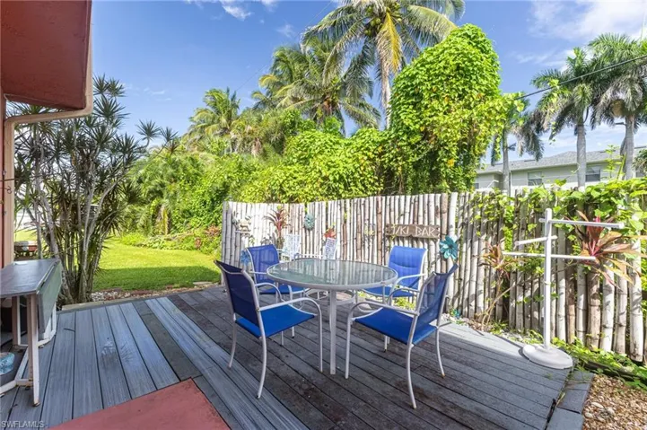 Deck featuring outdoor dining space and a lawn