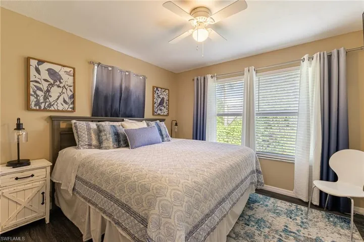 Bedroom featuring dark wood finished floors and ceiling fan