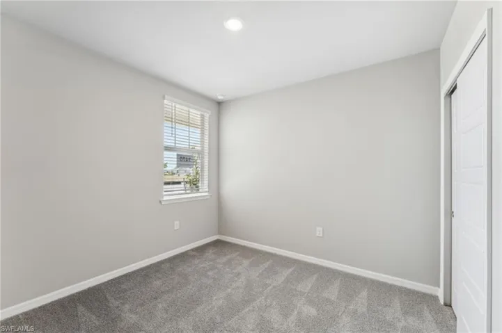 Unfurnished bedroom with carpet flooring and a closet