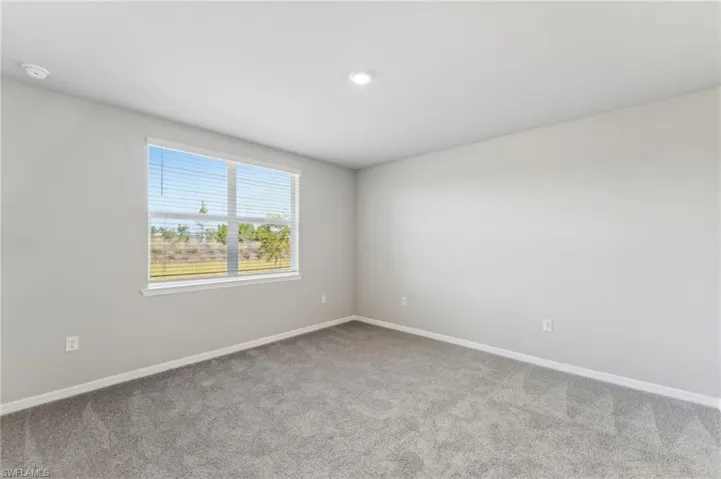 Unfurnished room featuring light carpet