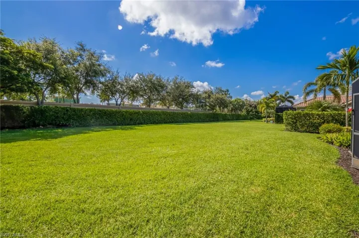 Expansive screened-in patio featuring a textured concrete surface and sturdy support columns