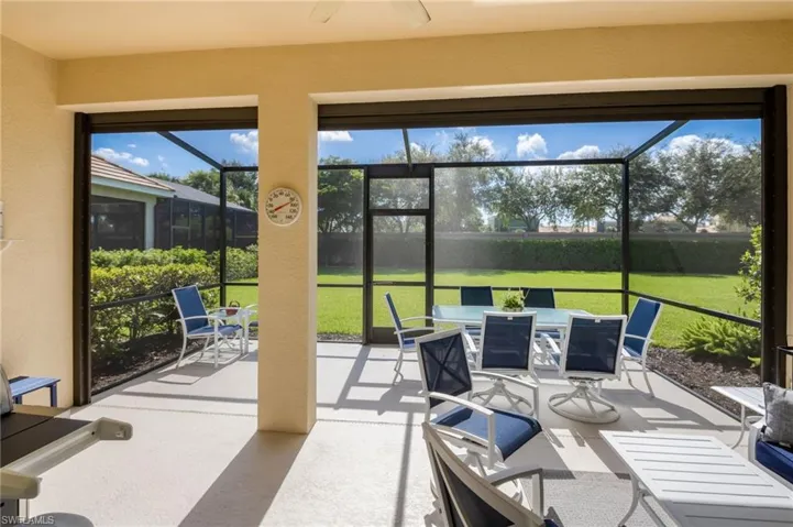 Screened outdoor living area with a textured concrete floor