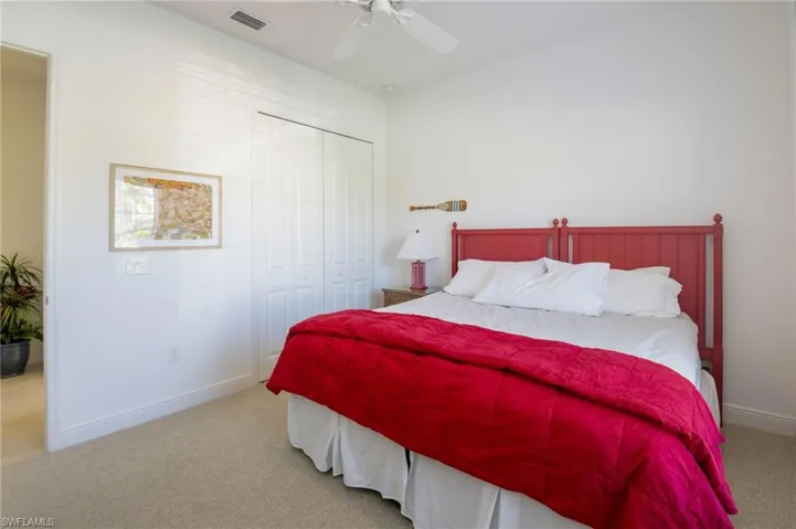 Carpeted bedroom with a window featuring horizontal blinds and a decorative valance