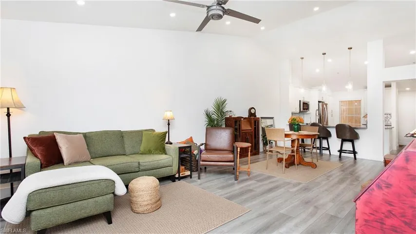 Living area featuring ceiling fan, light wood-style floors, high vaulted ceiling, and recessed lighting