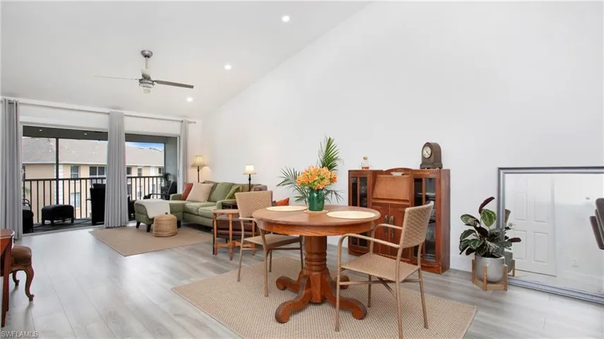 Dining room featuring light wood-style floors, ceiling fan, vaulted ceiling, and recessed lighting