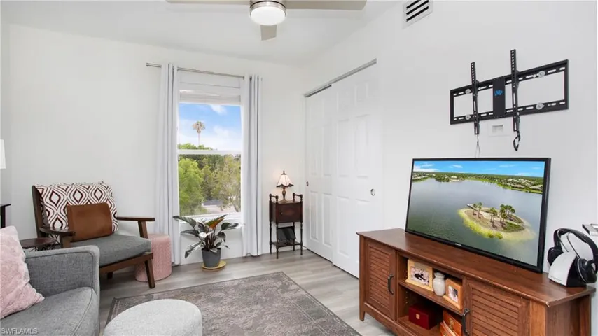Living room with a ceiling fan and light wood-style floors