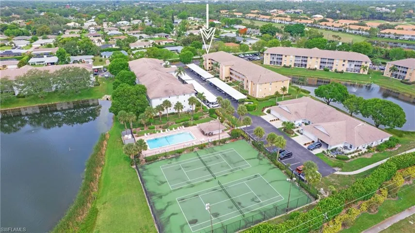 Drone / aerial view of a nearby body of water and a pool