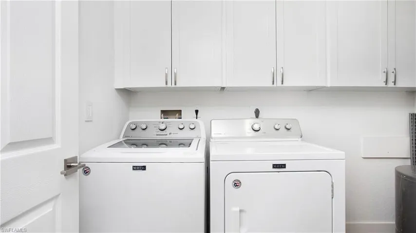 Laundry room featuring washing machine and dryer and cabinet space