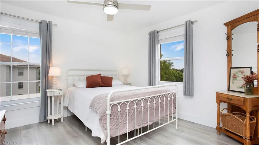 Bedroom featuring wood finished floors, ceiling fan, and baseboards