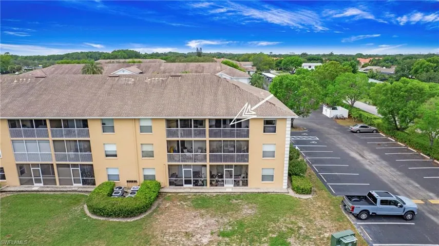 View of property featuring uncovered parking
