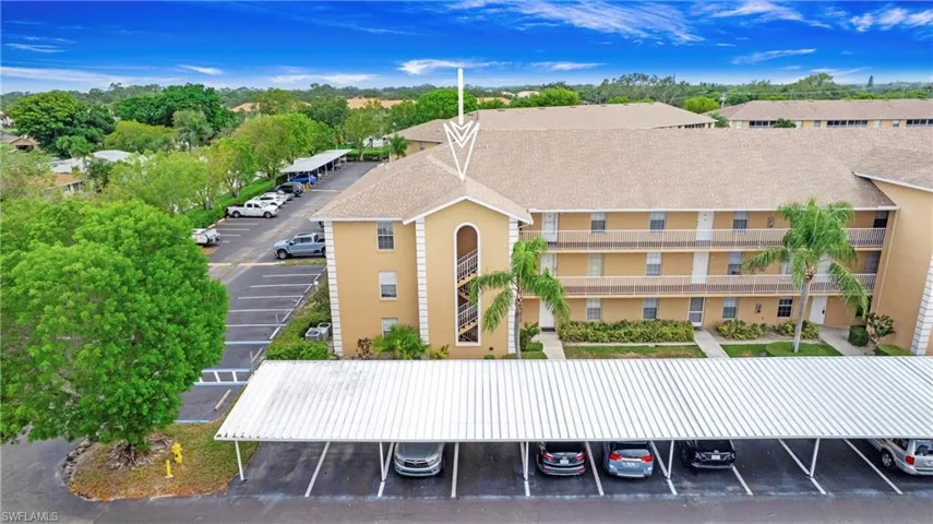 View of property featuring uncovered parking