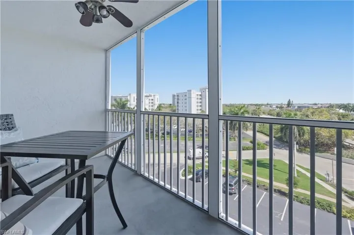 Balcony featuring a sunroom and a ceiling fan