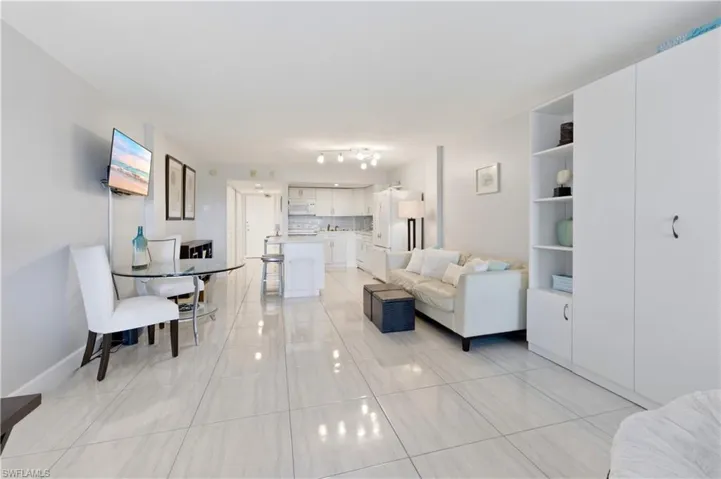 Living area featuring light tile patterned floors and baseboards