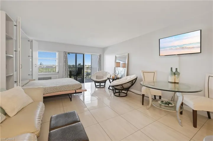 Bedroom with access to outside and light tile patterned flooring