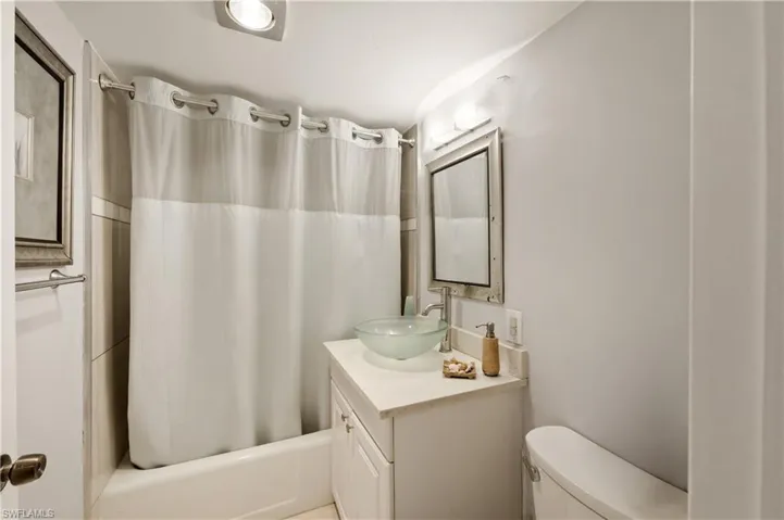 Full bath featuring vanity and shower / tub combo with curtain