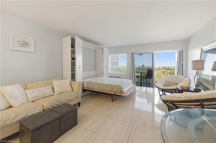 Bedroom featuring tile patterned floors and access to exterior