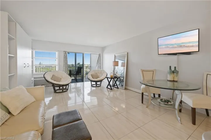 Living room featuring light tile patterned floors and baseboards
