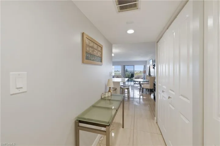 Entryway with light tile patterned flooring and recessed lighting