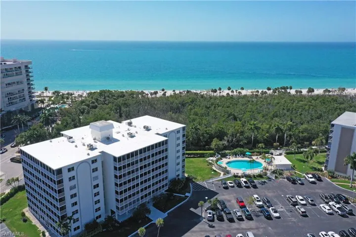 Aerial view of a pool and a large body of water