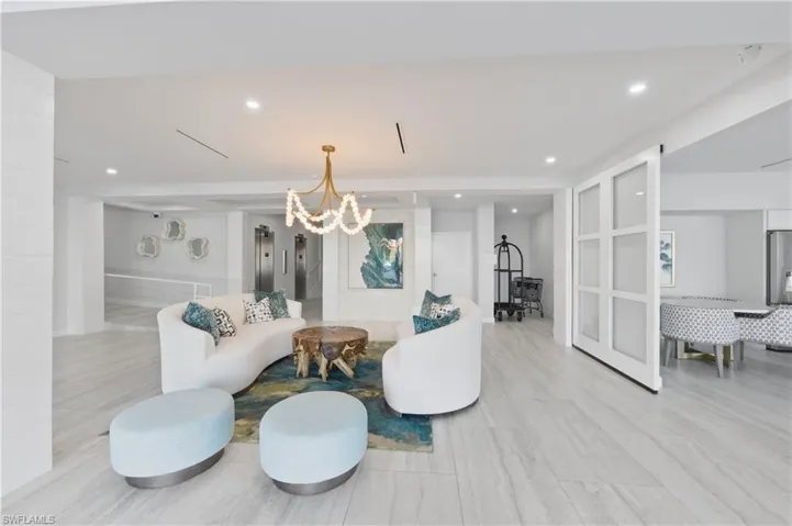 Building Living area featuring elevator and a chandelier